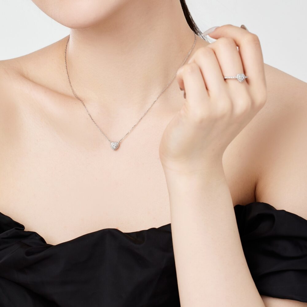 Woman wearing sterling silver heart shape ring and necklace